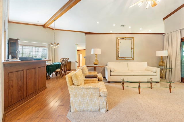 living area with ceiling fan with notable chandelier, recessed lighting, light wood-type flooring, visible vents, and ornamental molding