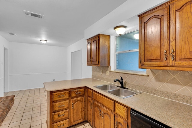503 Bluebonnet Ln, Red Oak, TX 75154 - kitchen featuring a sink, brown cabinetry, a peninsula, backsplash, and visible vents