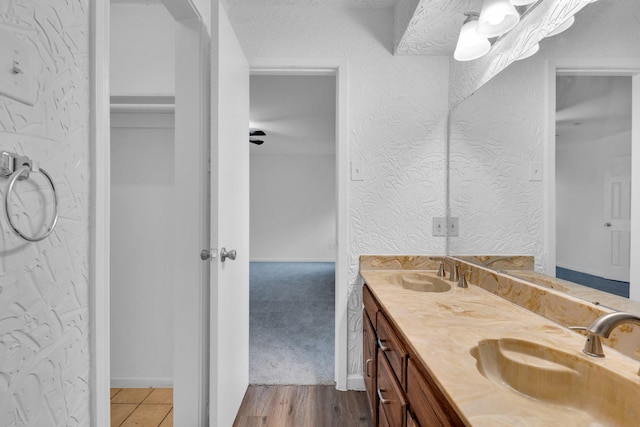 503 Bluebonnet Ln, Red Oak, TX 75154 - bathroom featuring a sink, a textured wall, and double vanity