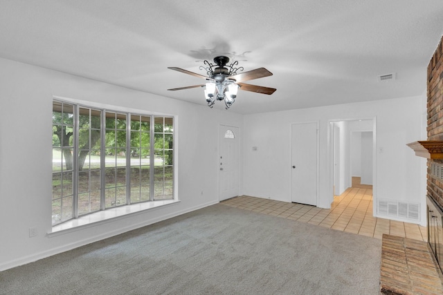 503 Bluebonnet Ln, Red Oak, TX 75154 - unfurnished living room featuring visible vents, light tile patterned flooring, a fireplace, baseboards, and ceiling fan