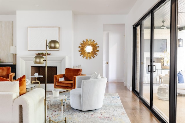 living area with light wood-style floors, baseboards, plenty of natural light, and french doors