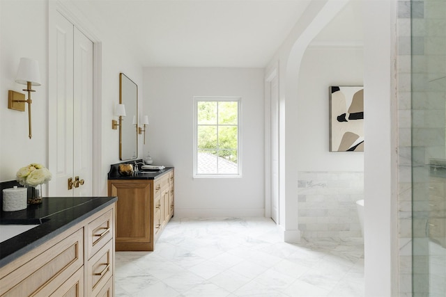 bathroom featuring a sink, marble finish floor, and two vanities