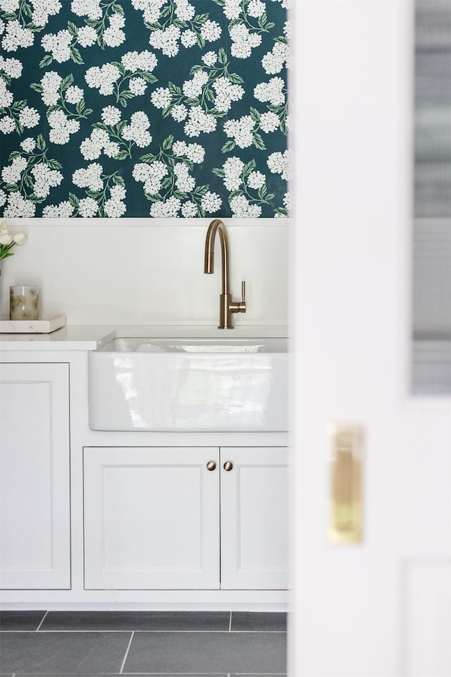 bar featuring tile patterned flooring and a sink