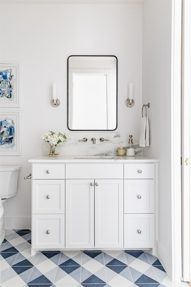 bathroom featuring vanity and toilet
