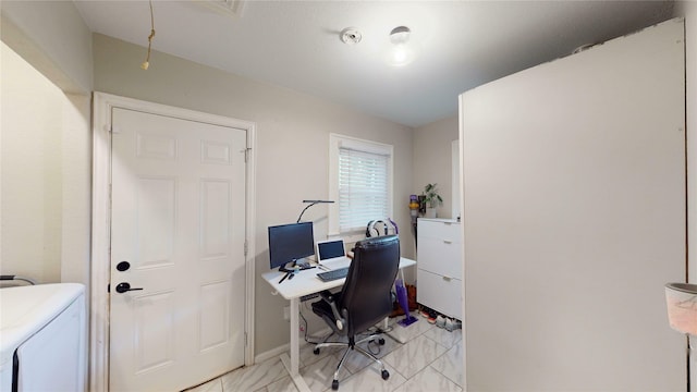 office space featuring washer / clothes dryer and baseboards