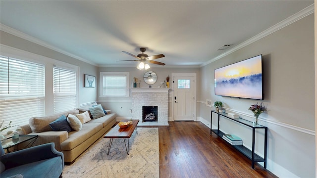 living area with baseboards, a ceiling fan, dark wood finished floors, and a fireplace