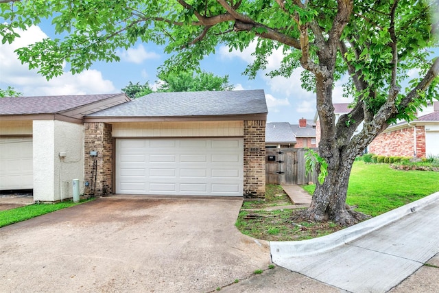 view of front of home featuring driveway, a gate, a garage, brick siding, and a shingled roof