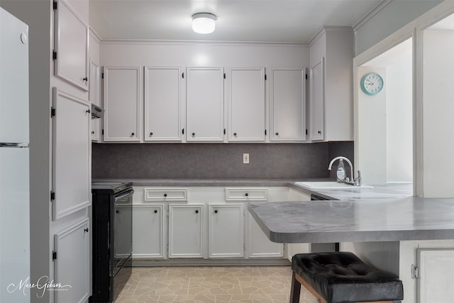 kitchen featuring electric range, a peninsula, a breakfast bar, white cabinetry, and a sink