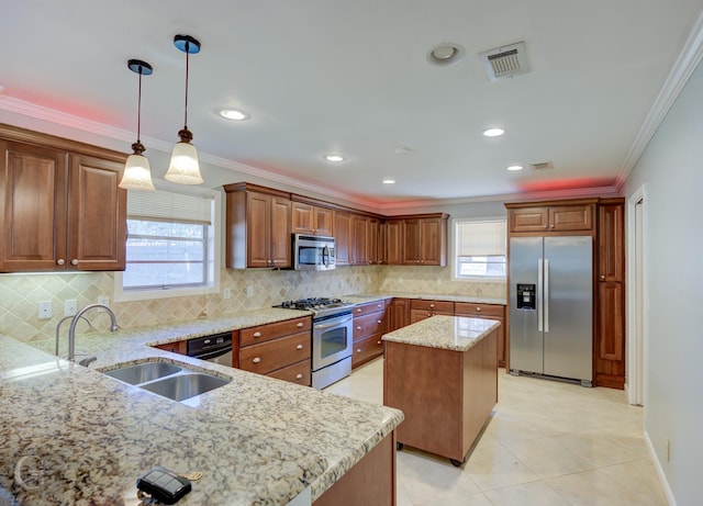 kitchen featuring light stone countertops, appliances with stainless steel finishes, a sink, visible vents, and ornamental molding