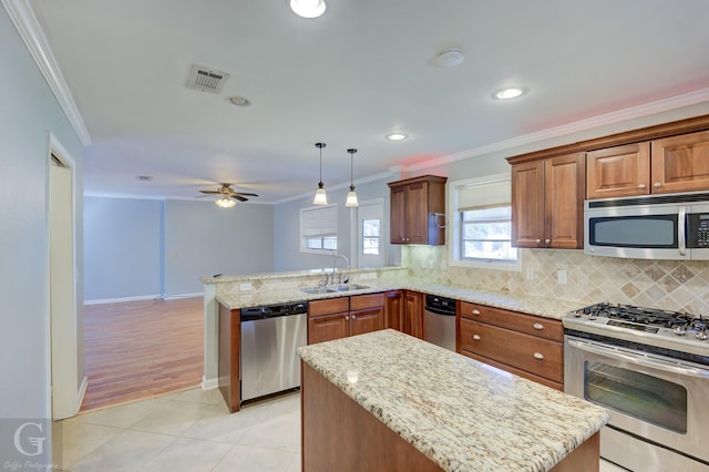 kitchen featuring stainless steel appliances, visible vents, and ornamental molding