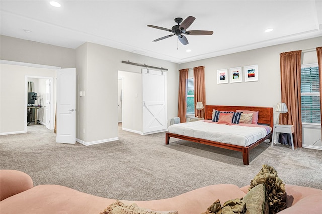 carpeted bedroom featuring a barn door, baseboards, and recessed lighting