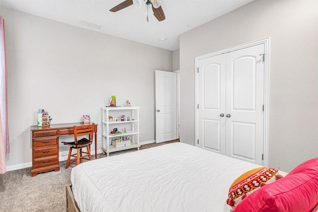 carpeted bedroom with a closet, visible vents, baseboards, and ceiling fan