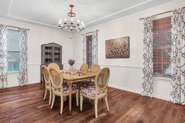 dining space featuring crown molding, wood finished floors, and a notable chandelier