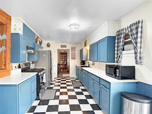 kitchen featuring black microwave, stainless steel gas range oven, wall chimney range hood, light countertops, and blue cabinets