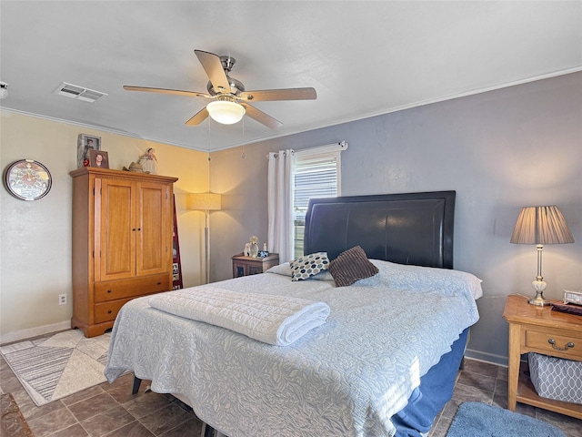 bedroom with visible vents, ornamental molding, baseboards, and ceiling fan