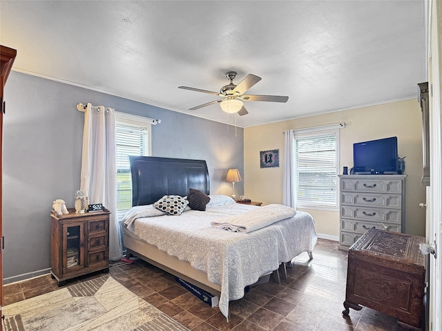 bedroom with crown molding, baseboards, multiple windows, and ceiling fan
