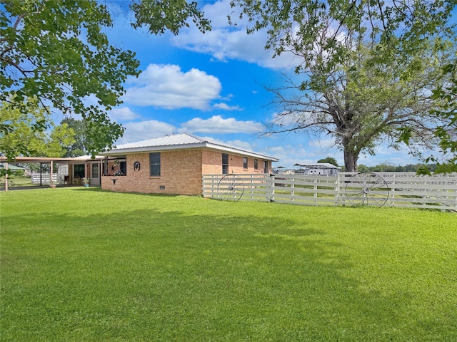 view of yard featuring a fenced backyard and a carport