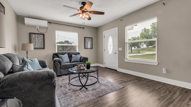 10018 Jackson Rd, Krum, TX 76249 - living area with baseboards, a ceiling fan, an AC wall unit, and dark wood-style flooring