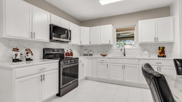 10018 Jackson Rd, Krum, TX 76249 - kitchen featuring white cabinets, stainless steel appliances, a sink, and light countertops