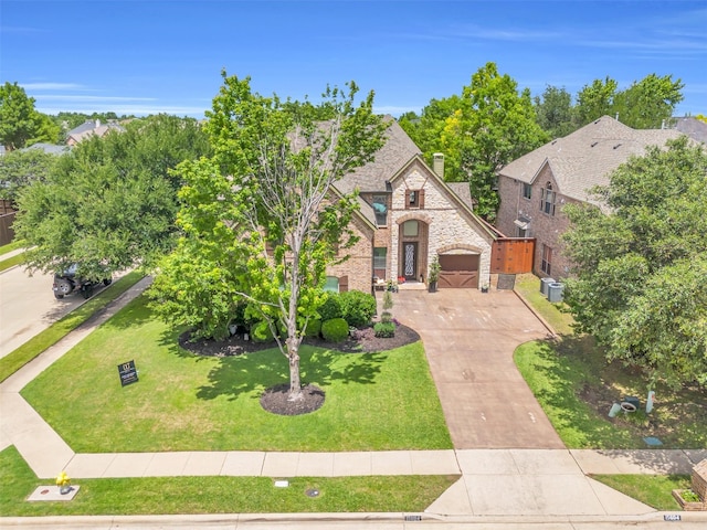 15604 Christopher Ln, Frisco, TX 75035 - french provincial home featuring stone siding, concrete driveway, a gate, a garage, and central air condition unit