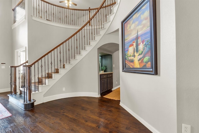 15604 Christopher Ln, Frisco, TX 75035 - stairs featuring baseboards, a towering ceiling, wood finished floors, arched walkways, and ceiling fan