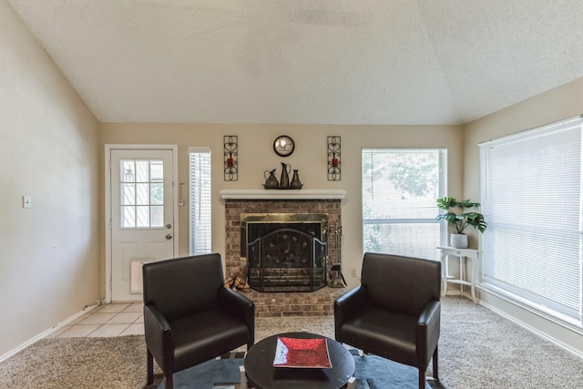 living area featuring baseboards, a fireplace, and light carpet