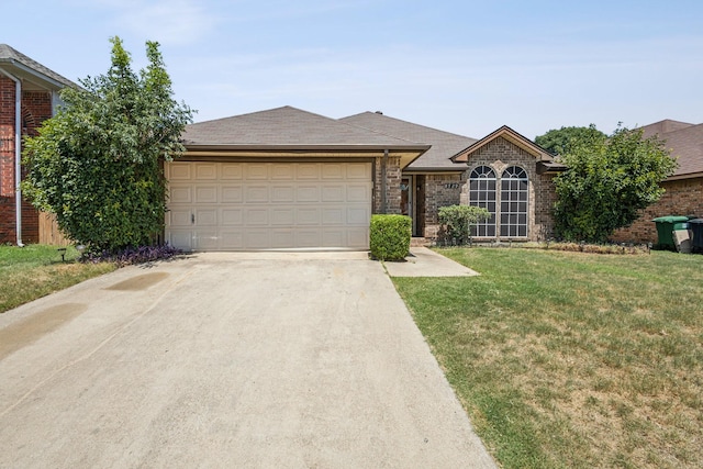 ranch-style house featuring brick siding, a garage, a front lawn, and driveway