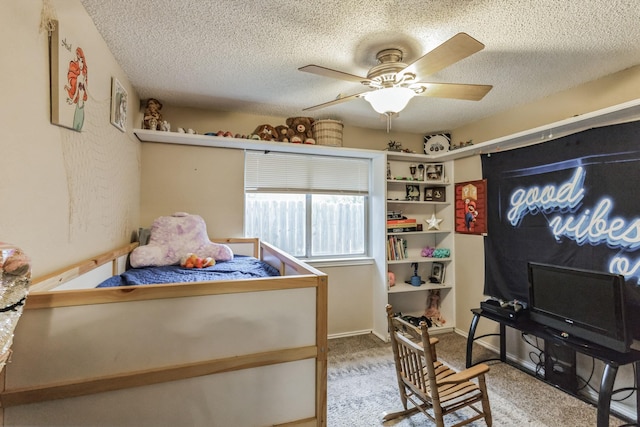 bedroom with carpet, a textured ceiling, and a ceiling fan