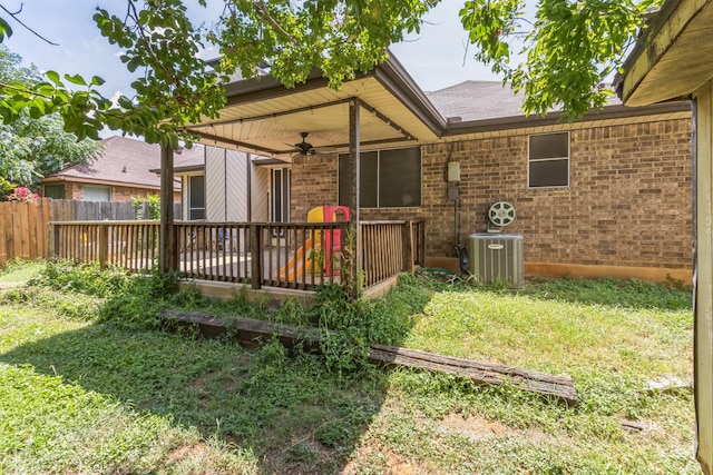 back of house with ceiling fan, central AC, fence, a deck, and brick siding