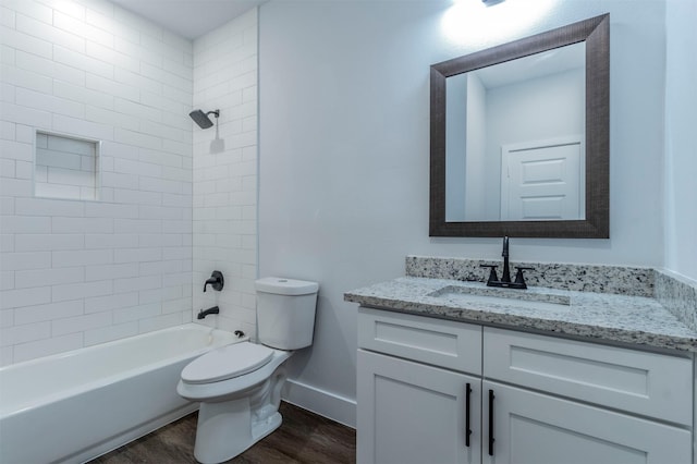 full bath featuring vanity, wood finished floors, toilet, baseboards, and shower / bath combination