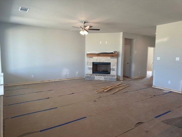 2471 Blackjack Oak Rd, Oak Ridge, TX 75161 - unfurnished living room with a stone fireplace, ceiling fan, and baseboards