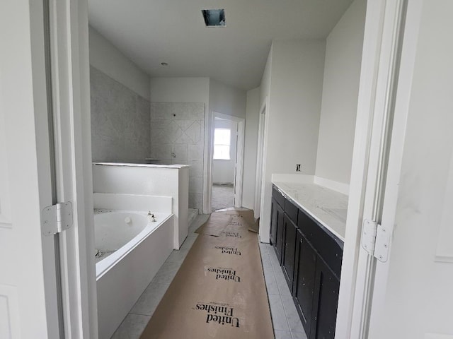 full bathroom featuring vanity, a tile shower, and a bath