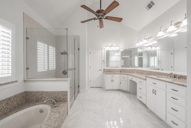 bathroom with lofted ceiling, healthy amount of natural light, a stall shower, and ceiling fan