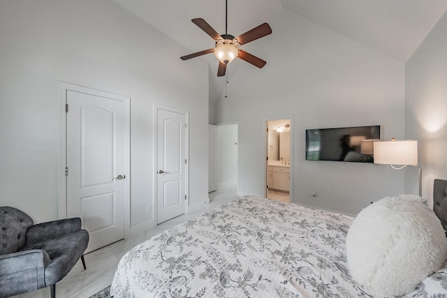 bedroom with high vaulted ceiling, ensuite bath, two closets, and ceiling fan
