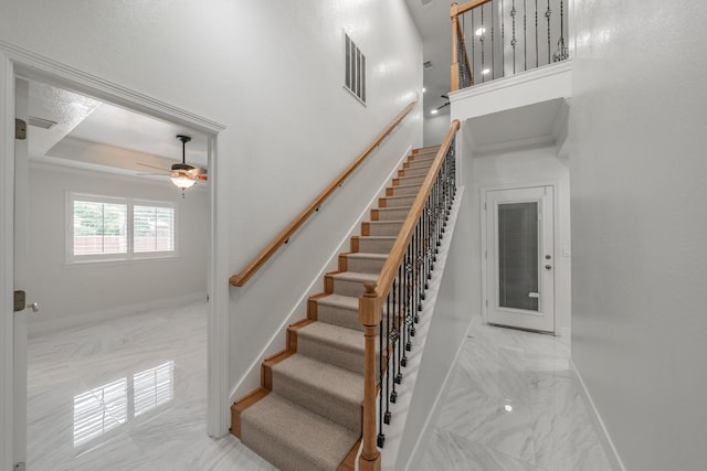 stairway featuring marble finish floors, baseboards, and ceiling fan