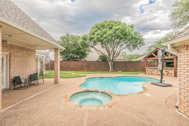 view of swimming pool with a patio, a fenced backyard, and a pool with connected hot tub