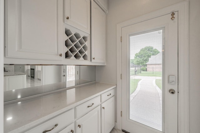 view of patio / terrace with exterior kitchen, fence, a gazebo, and beverage cooler