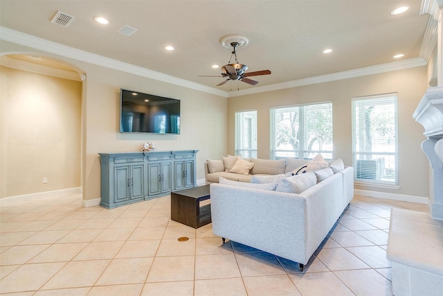 living room with crown molding, a ceiling fan, baseboards, light tile patterned floors, and visible vents