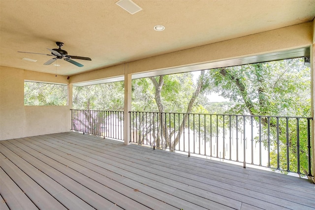wooden deck with a ceiling fan