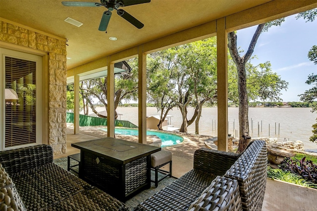view of patio / terrace featuring a fenced in pool, a water view, ceiling fan, and fence private yard
