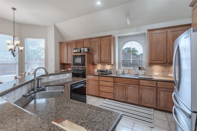 3609 Dandelion Dr, Plano, TX 75093 - kitchen with black appliances, a sink, backsplash, a chandelier, and lofted ceiling