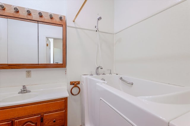 bathroom featuring vanity and a bath