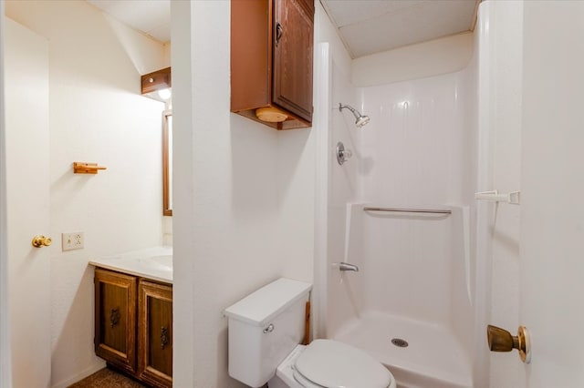 bathroom with vanity, a shower, and toilet