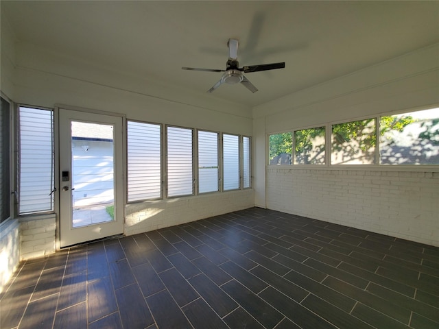 unfurnished sunroom featuring brick wall