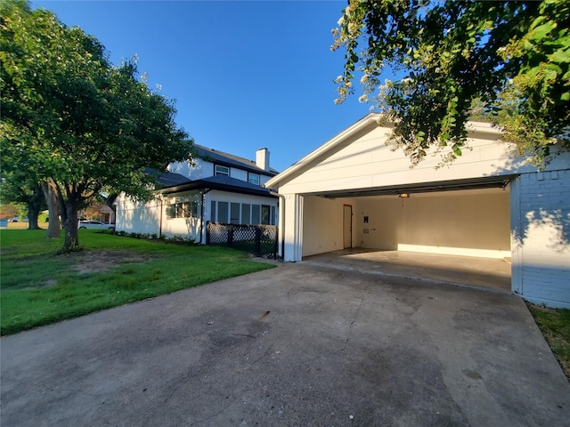 view of front of property with concrete driveway, brick siding, and a front lawn