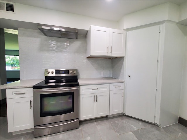 kitchen featuring light countertops, stainless steel electric range, exhaust hood, and white cabinets