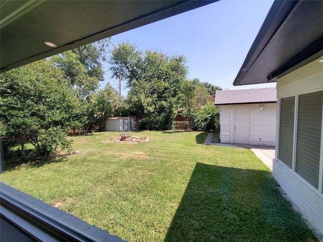 view of yard with an outdoor structure and a shed