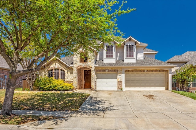 4001 Bamberg Ln, Fort Worth, TX 76244 - view of front of home with a garage, a front yard, stone siding, a shingled roof, and concrete driveway