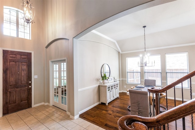 4001 Bamberg Ln, Fort Worth, TX 76244 - entrance foyer featuring lofted ceiling, baseboards, a chandelier, crown molding, and arched walkways