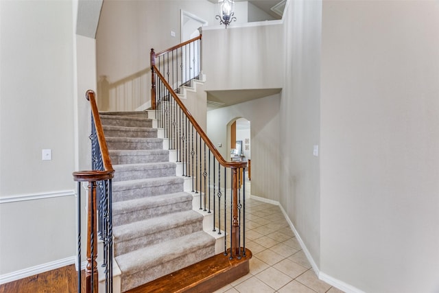 4001 Bamberg Ln, Fort Worth, TX 76244 - staircase with arched walkways, baseboards, and tile patterned flooring